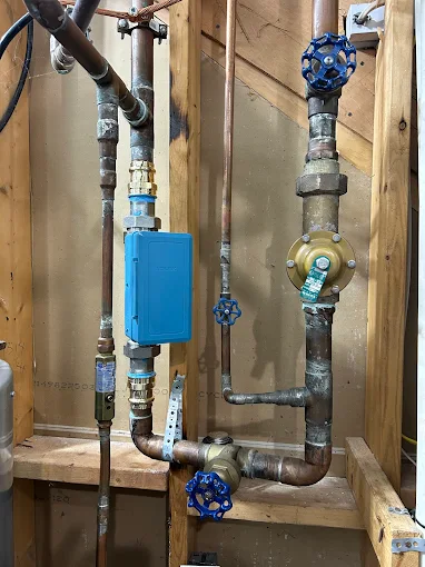 Copper main water line with shutoff valves and pressure regulator